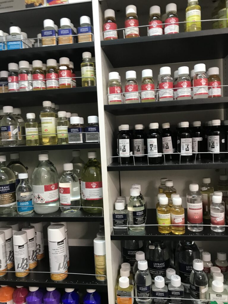 Shelves of varnish, linseed oil, mineral spirits, and turpentine at Profiart, an art supply store in Bucharest