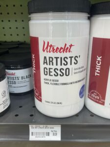 a photo of a white Utrecht bottle of artist's gesso on a shelf